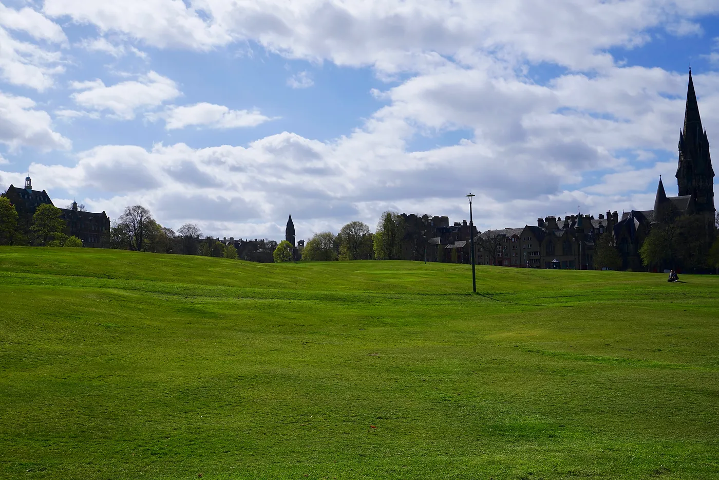 Bruntsfield's grass rolling west.