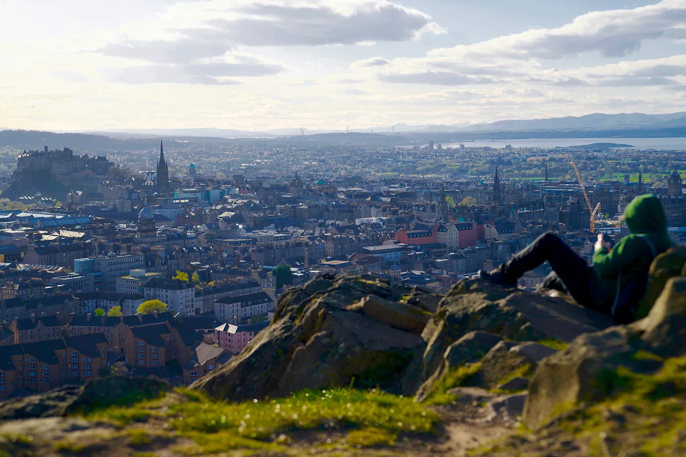 A fellow in a green hoodie relaxing in the nooks of the Crags.
