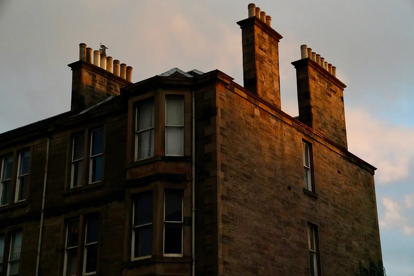 The sun hitting the side of an apartment building.