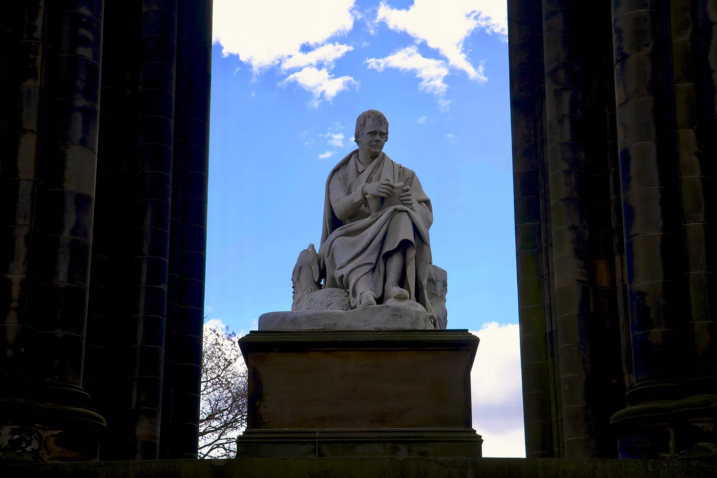 A statue of Sir Walter Scott, the famous jurist, poet, and writer, in the center of his monument.