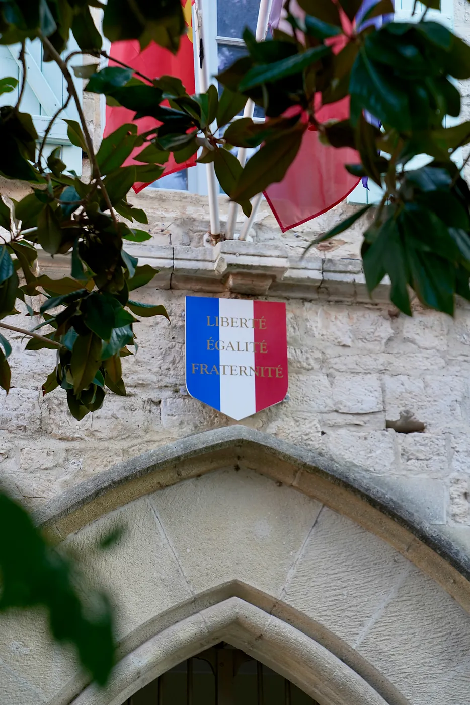 The motto of France displayed on a shield above the entrance to a building used by the government.