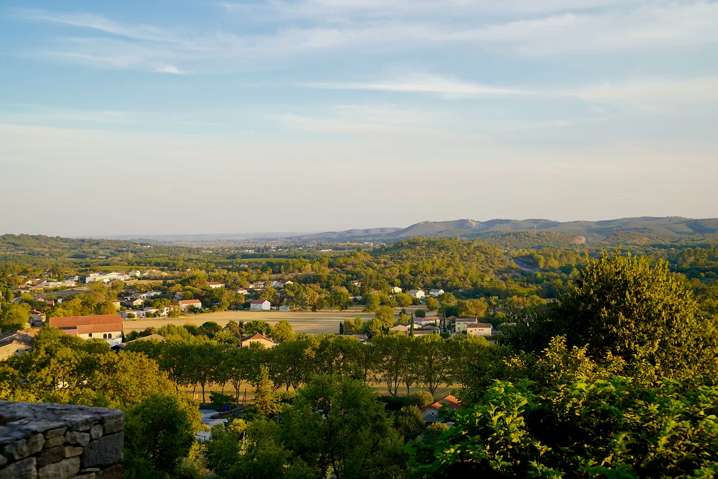 The countryside surrounding Vézénobres beneath a blue sky.