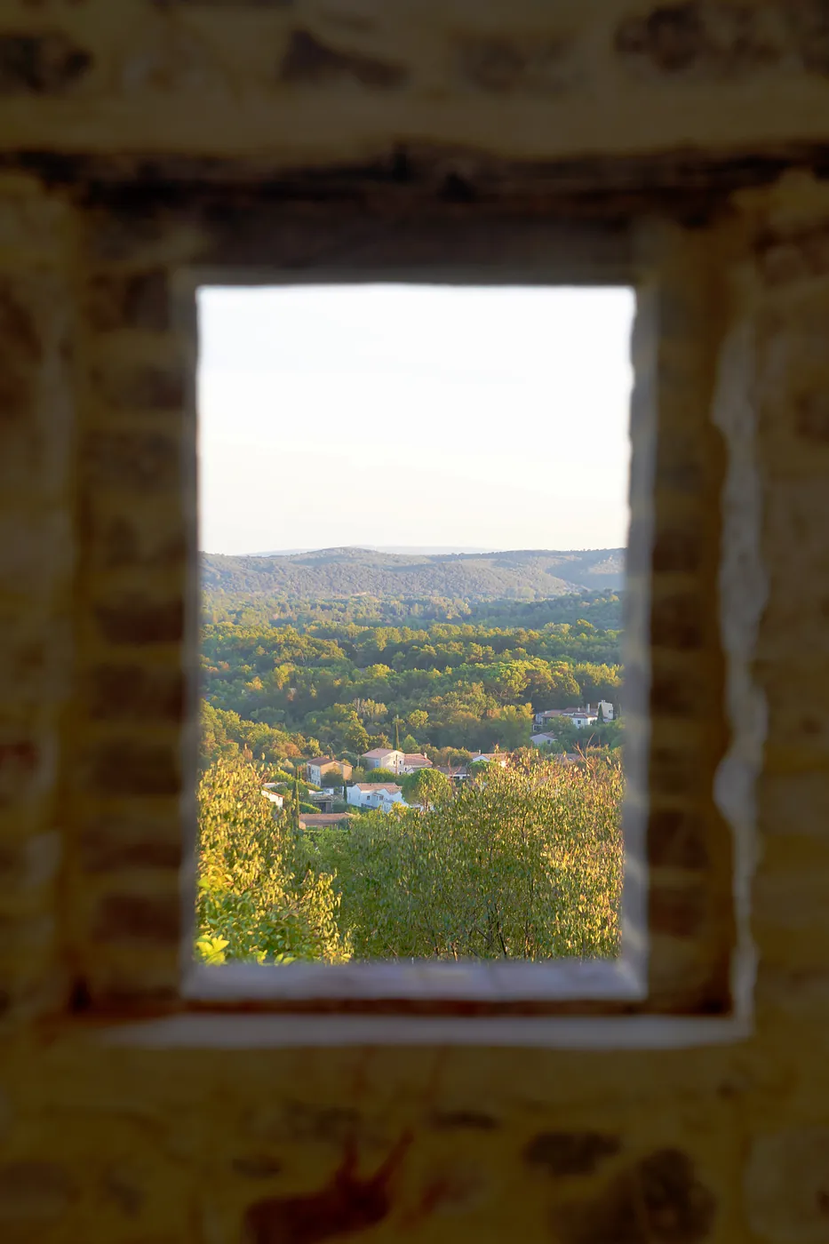 The countryside surrounding Vézénobres through an exposed window.