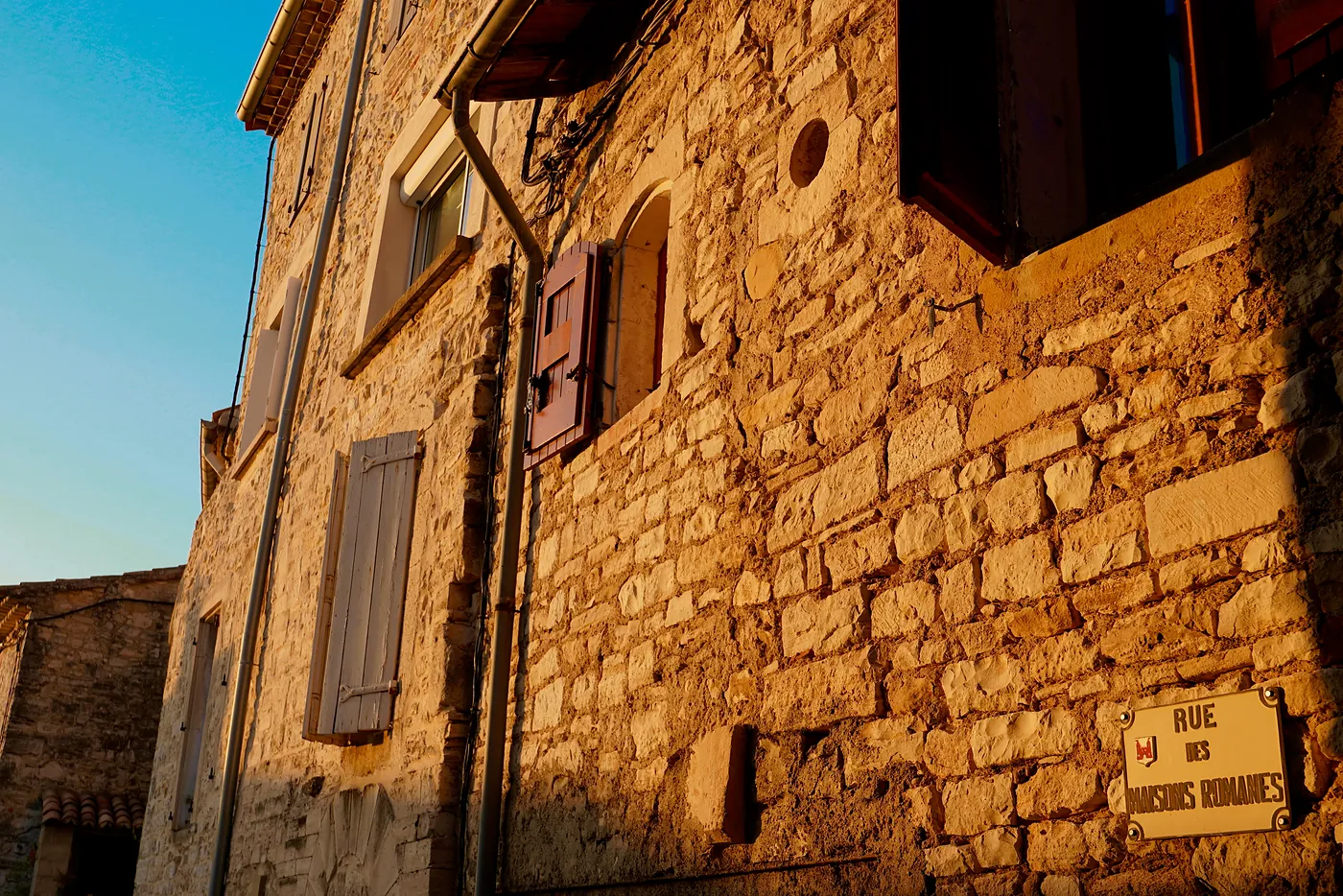 A storied façade with many windows bathed in the evening's light.