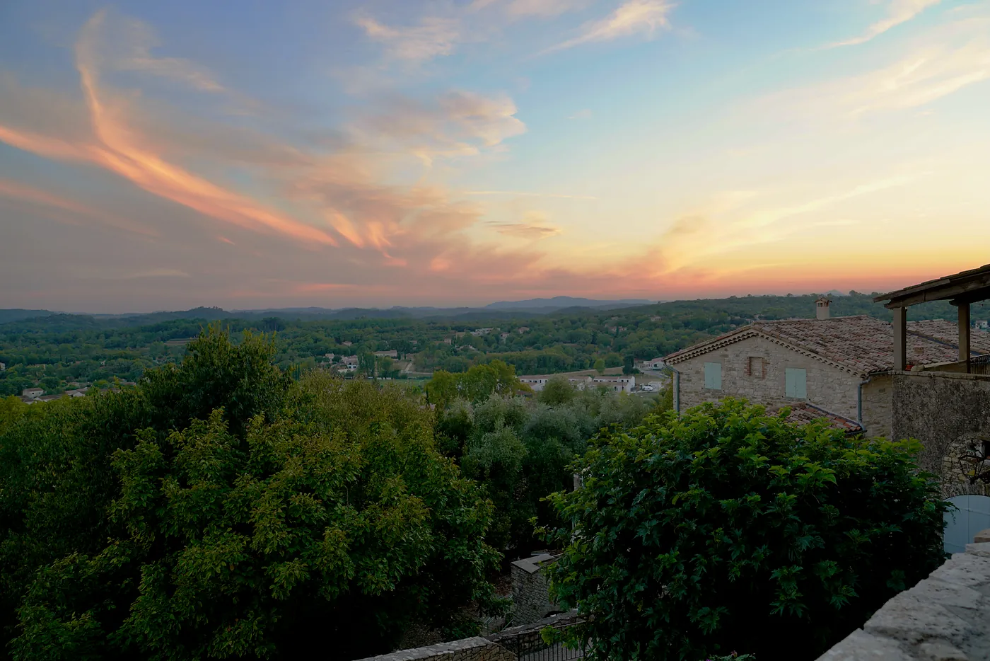 A view of the sunset over the countryside.