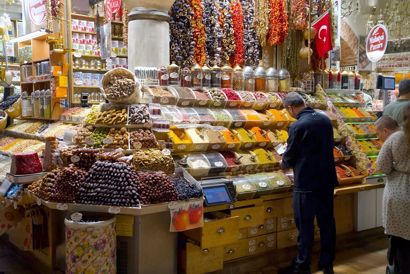 A larger stall with cabinets full of spices and other luxurious treats.