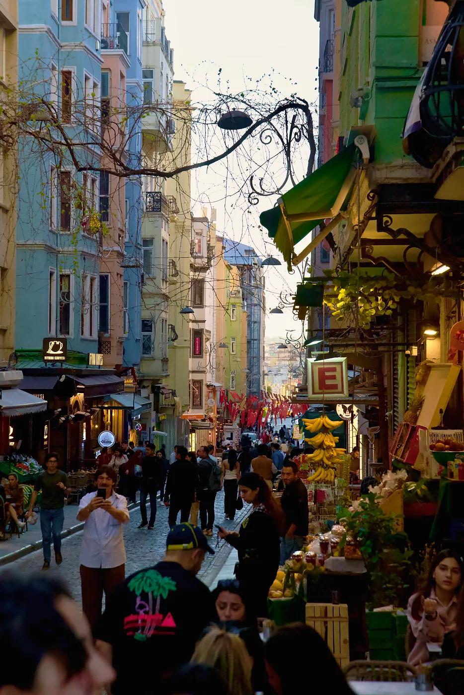 A vibrant street leading away from the Galata Tower.