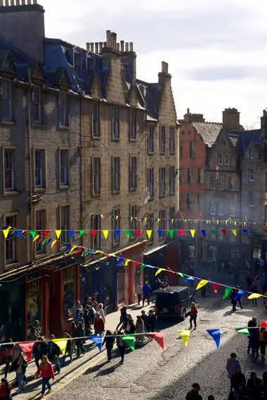 Colourful bunting strung across a cobbled street in Edinburgh's Old Town